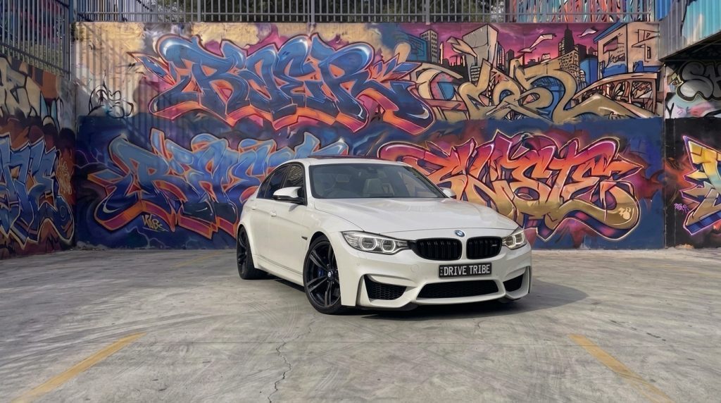 White 2016 BMW M3 Competition F80 Stage 1, front three-quarter view, available for hire in Sydney