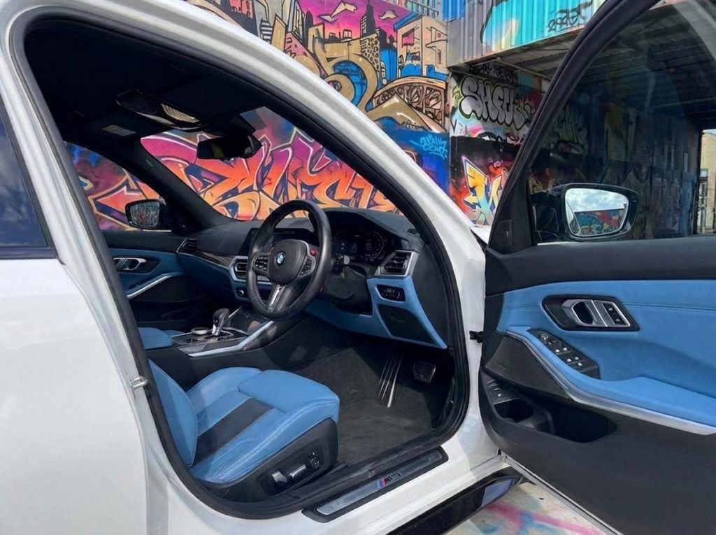 Front seats of the white 2021 BMW M3 Competition G80, available for hire in Sydney
