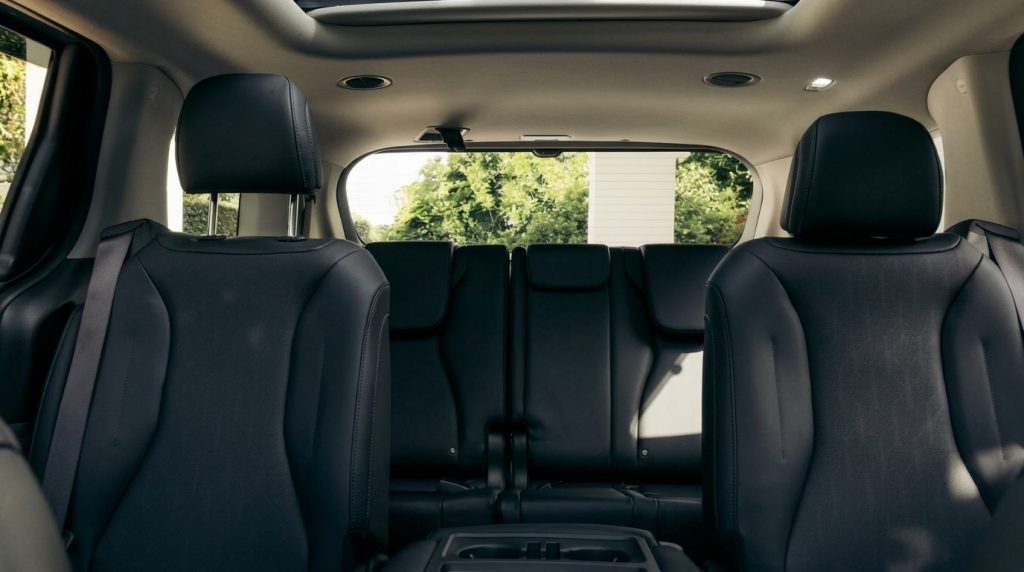 Rear seats of the black 2025 Kia Carnival GT-Line Hybrid, available for hire in Sydney