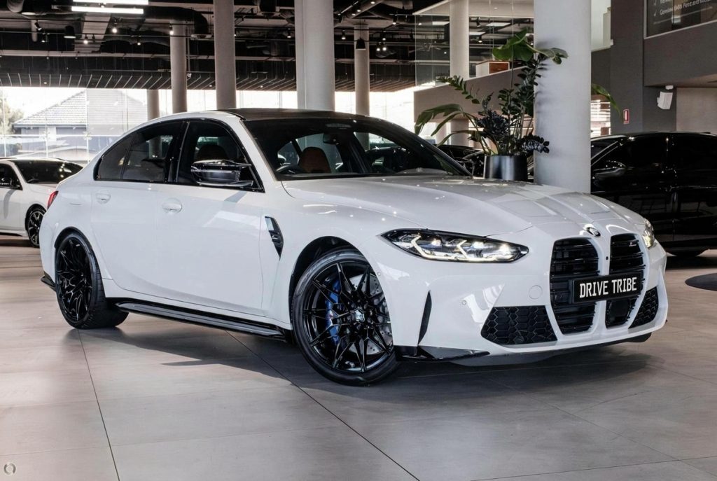 White 2024 BMW M3 Competition G80 xDrive, front three-quarter view, available for hire in Sydney