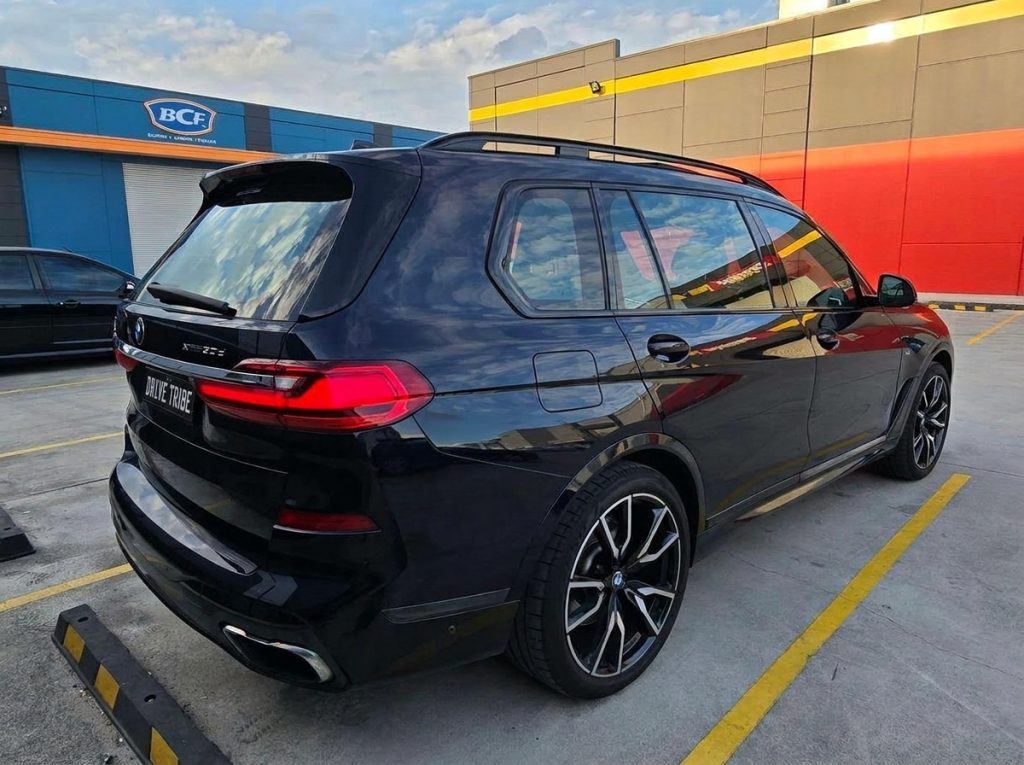 Blue 2019 BMW X7 xDrive30d, rear three-quarter view, available for hire in Sydney