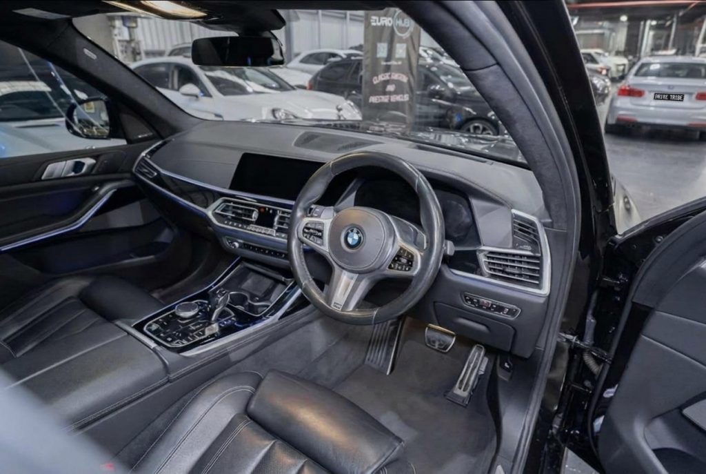 Steering wheel of the blue 2019 BMW X7 xDrive30d, available for hire in Sydney