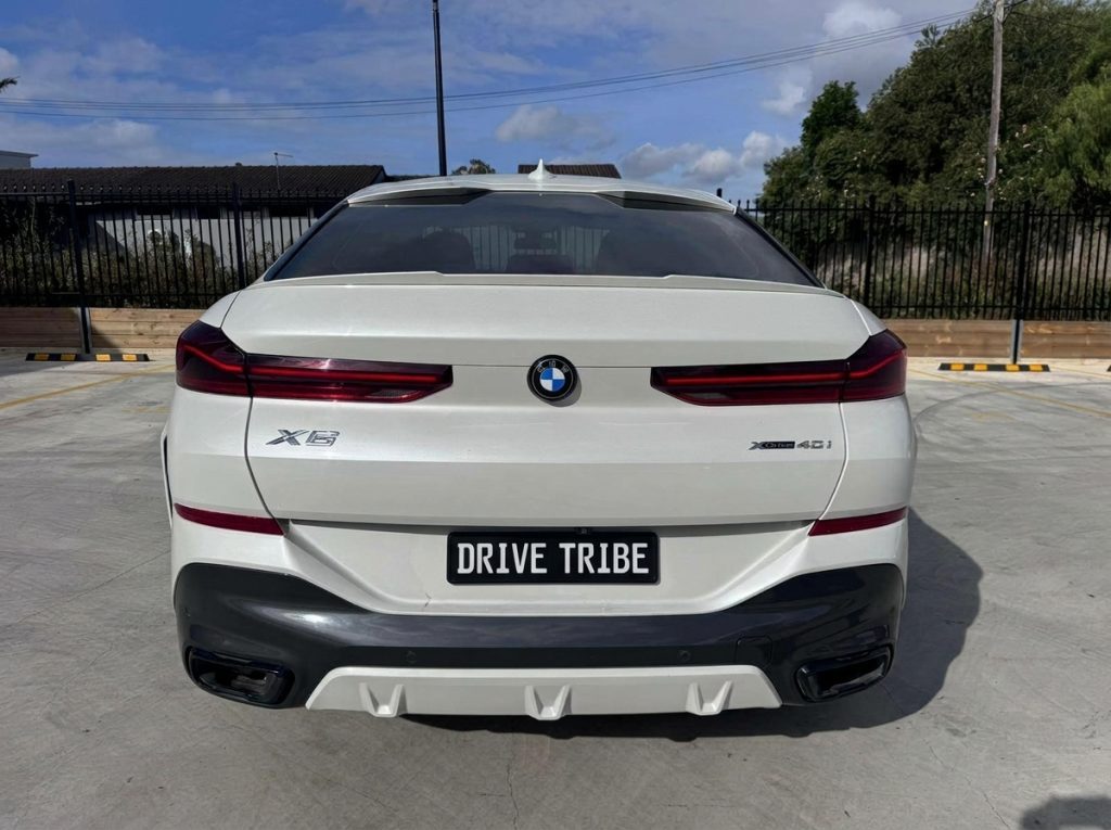 White 2022 BMW X6 xDrive40i M Sport, rear view, available for hire in Sydney