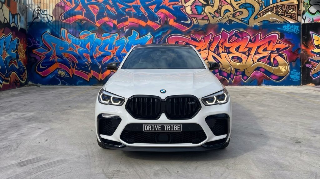 White BMW X6 M Competition, front view, available for hire in Sydney