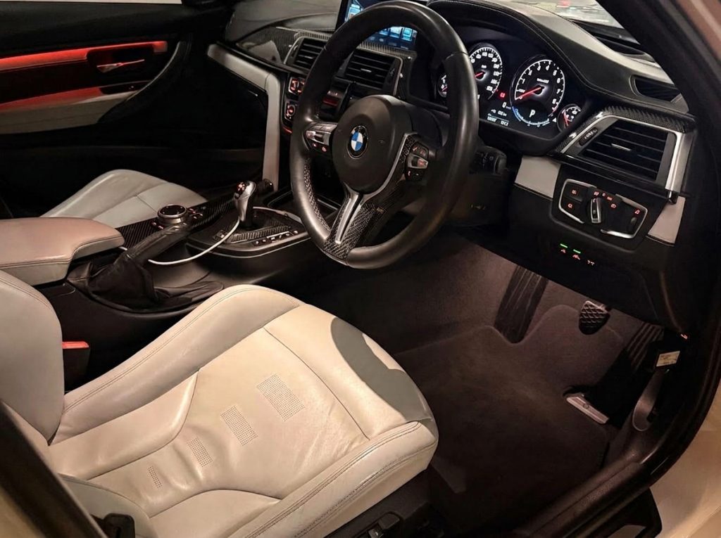 Dashboard of the white 2016 BMW M3 Competition F80, available for hire in Sydney