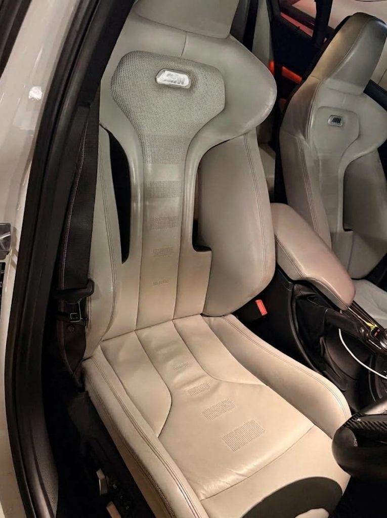 Front seats of the white 2016 BMW M3 Competition F80, available for hire in Sydney