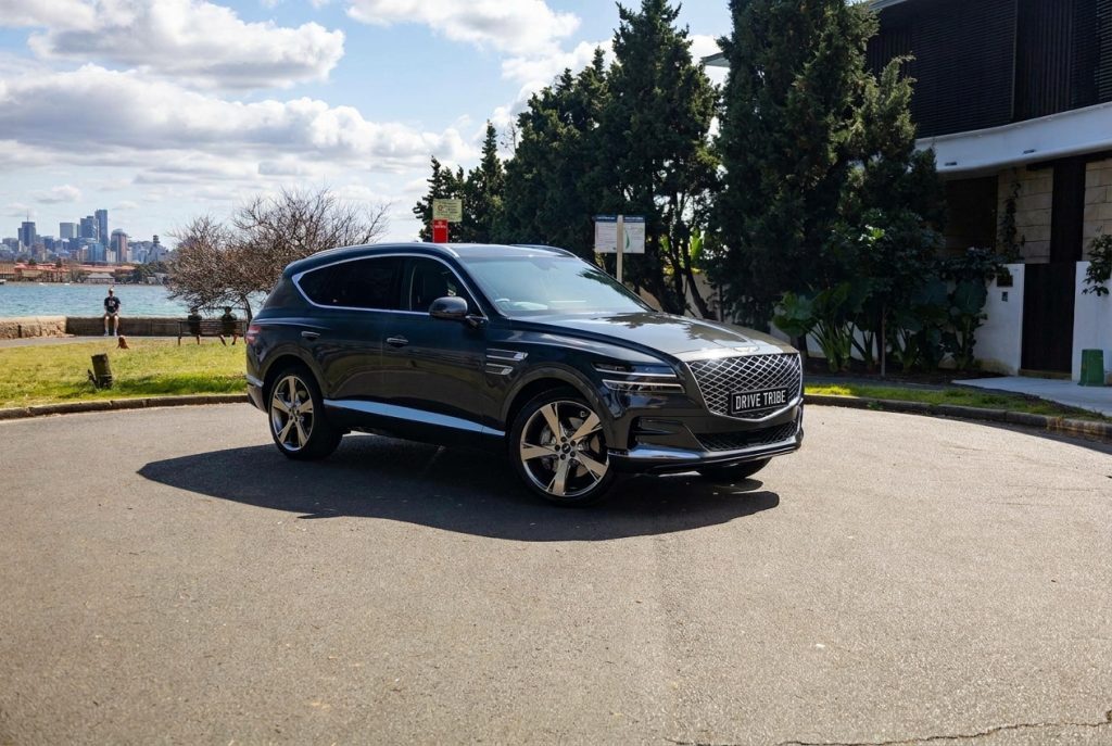 Grey 2023 Genesis GV80 3.0D Lux 7-Seat, front three-quarter view, available for hire in Sydney