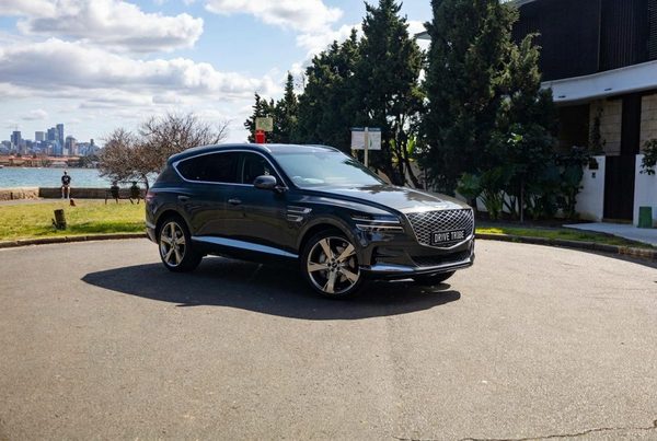 Grey 2023 Genesis GV80 3.0D Lux 7-Seat, front three-quarter view, available for hire in Sydney