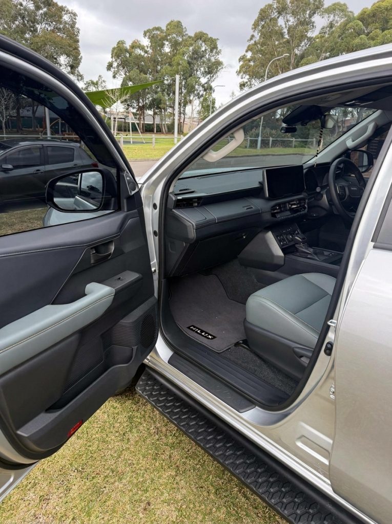 Front seats of the silver 2026 Toyota HiLux Rogue 4x4, available for hire in Sydney