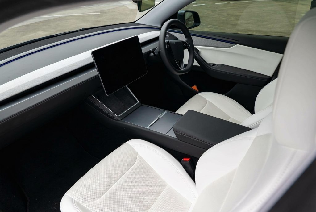 Front seats of the silver 2025 Tesla Model Y RWD, available for hire in Sydney