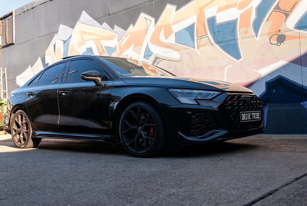 Black 2022 Audi RS 3 Sportback, front three-quarter view, available for hire in Sydney