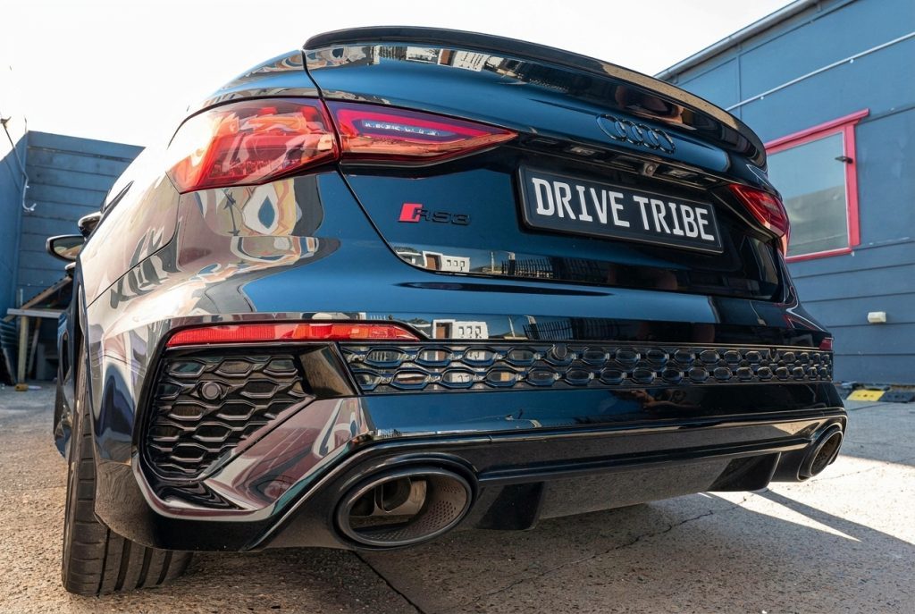Black 2022 Audi RS 3 Sportback, rear three-quarter view, available for hire in Sydney