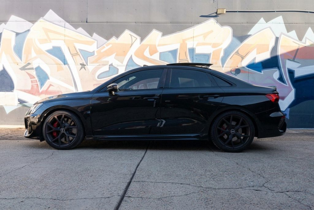 Black 2022 Audi RS 3 Sportback, side profile, available for hire in Sydney