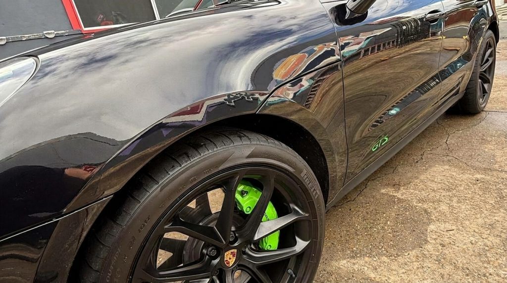 Wheel of the black 2024 Porsche Macan GTS, available for hire in Sydney